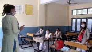 Students attend a class at Government School after schools reopened partially